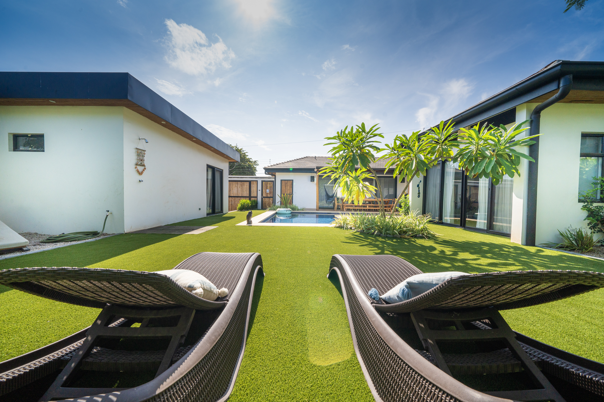 Lawn lounge chairs with pool view